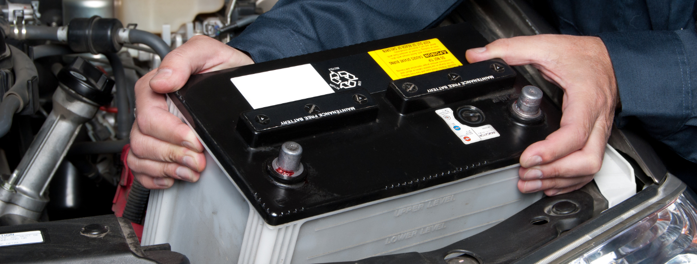 Mechanic holding a battery