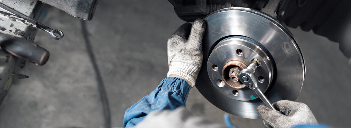 Mechanic fitting a new brake disc